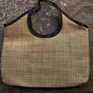 Straw tote with green and white lining, black trim